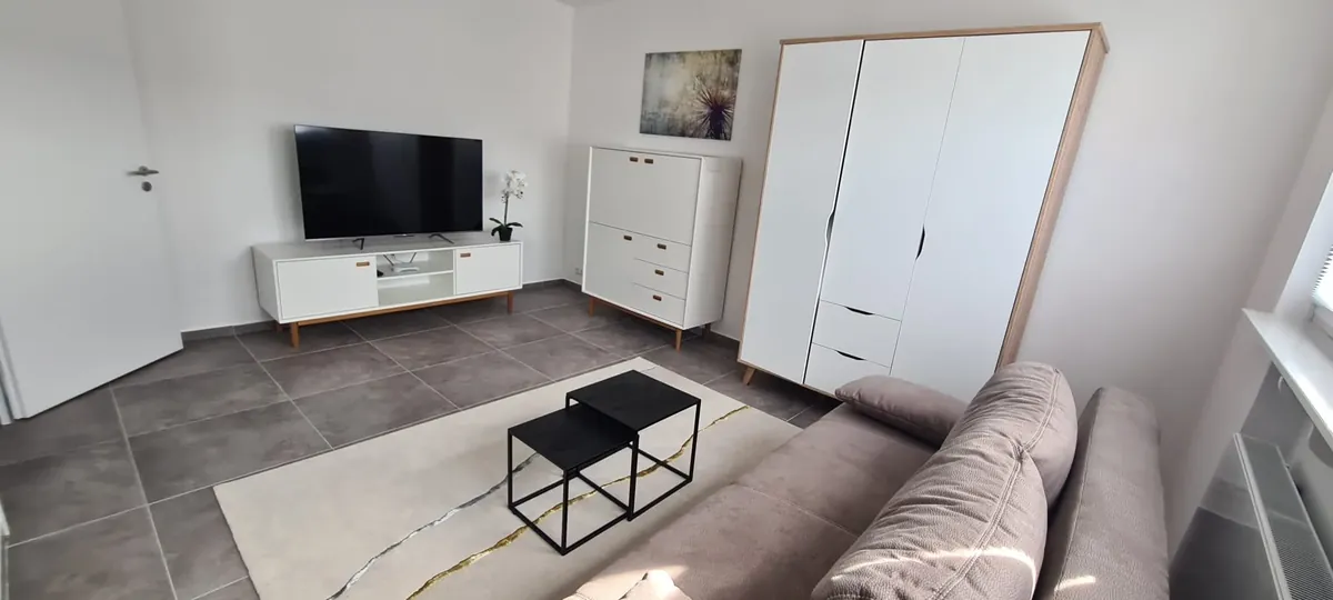 Wohnbereich mit Sofa, Smart-TV und Kleiderschrank – Modernes Apartment Obergeschoss, Quiet Apartments Bergisch Gladbach-Refrath